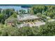 Aerial view of community center with swimming pool, lush landscaping and lake in the background at 11125 Shelter Cove Loop, New Port Richey, FL 34654