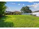 Expansive backyard with screened-in pool and plenty of green space at 11125 Shelter Cove Loop, New Port Richey, FL 34654