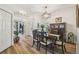Charming dining room with luxury vinyl plank flooring, a modern chandelier, and convenient access to other living areas at 11125 Shelter Cove Loop, New Port Richey, FL 34654