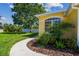 Landscaped front yard with walkway and an inviting view of the home's exterior at 11125 Shelter Cove Loop, New Port Richey, FL 34654