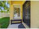 Inviting front entry featuring a dark-colored door and charming decorative accents at 11125 Shelter Cove Loop, New Port Richey, FL 34654