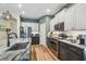 Modern kitchen with granite counters, stainless steel appliances, and dark lower and light upper cabinets at 11125 Shelter Cove Loop, New Port Richey, FL 34654