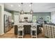 Open concept kitchen with stainless appliances, large island, and views to living space at 11125 Shelter Cove Loop, New Port Richey, FL 34654