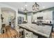 Bright kitchen with stainless steel appliances, center island, and view into living spaces at 11125 Shelter Cove Loop, New Port Richey, FL 34654