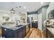 Well-lit kitchen featuring an island with seating, stainless appliances and pendant lighting at 11125 Shelter Cove Loop, New Port Richey, FL 34654