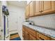 Functional laundry room with front load washer/dryer, storage cabinets and tile backsplash at 11125 Shelter Cove Loop, New Port Richey, FL 34654