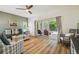 The spacious living room features a ceiling fan, sliding glass door leading to the pool area, and comfortable seating at 11125 Shelter Cove Loop, New Port Richey, FL 34654