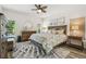 Comfortable main bedroom featuring a ceiling fan and a king-size bed with decorative pillows at 11125 Shelter Cove Loop, New Port Richey, FL 34654