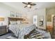 Spacious main bedroom with a ceiling fan, stylish decor, and views into the luxurious bathroom at 11125 Shelter Cove Loop, New Port Richey, FL 34654