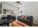 Cozy office space with wood-look flooring, desk and chair, and comfortable leather sofa at 11125 Shelter Cove Loop, New Port Richey, FL 34654