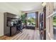 Bright office featuring a large arched window and built in cabinets and shelving at 11125 Shelter Cove Loop, New Port Richey, FL 34654