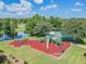 Aerial view of a community playground with a variety of play equipment and a cushioned play surface at 11125 Shelter Cove Loop, New Port Richey, FL 34654
