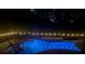 Outdoor pool and spa lit up at night with string lights, ideal for relaxing evenings at 11125 Shelter Cove Loop, New Port Richey, FL 34654