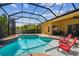 Sparkling screened pool with shallow area and sunny backyard views at 11125 Shelter Cove Loop, New Port Richey, FL 34654