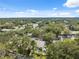 Aerial view of houses surrounded by green trees, and lush landscaping at 1136 Thayer St, Safety Harbor, FL 34695