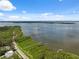 Scenic aerial view showcasing waterfront property, private docks, and serene bay at 1136 Thayer St, Safety Harbor, FL 34695