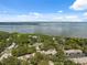 Panoramic aerial view showcasing a community by the water with lush greenery at 1136 Thayer St, Safety Harbor, FL 34695