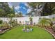 Landscaped backyard featuring manicured lawn, decorative plants, and a serene garden area at 1136 Thayer St, Safety Harbor, FL 34695