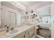 Bathroom vanity with a large mirror and updated fixtures, adjacent to the main bedroom at 1136 Thayer St, Safety Harbor, FL 34695