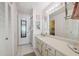 Bright bathroom with a long vanity, multiple mirrors, and ample storage space at 1136 Thayer St, Safety Harbor, FL 34695