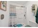 Clean bathroom featuring a walk-in shower with modern fixtures and a stylish shower curtain at 1136 Thayer St, Safety Harbor, FL 34695