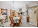 Dining area features a round table, chandelier, and view to the kitchen at 1136 Thayer St, Safety Harbor, FL 34695