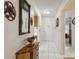 Inviting hallway featuring tile flooring, decorative accents, and a view of the interior spaces at 1136 Thayer St, Safety Harbor, FL 34695