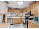 Kitchen features stainless steel appliances, light countertops, and wood cabinets at 1136 Thayer St, Safety Harbor, FL 34695