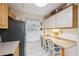 Eat-in kitchen with white cabinets, tile floors, and lots of sunlight at 1136 Thayer St, Safety Harbor, FL 34695