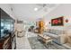 Inviting living room with neutral furniture, tile floors, and a view into the Florida room at 1136 Thayer St, Safety Harbor, FL 34695