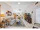Open-concept living room boasts neutral colors, tile floors, a ceiling fan, and natural light from a skylight at 1136 Thayer St, Safety Harbor, FL 34695