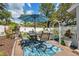 A furnished patio with an umbrella and garden view create an outdoor oasis for relaxing and entertaining at 1136 Thayer St, Safety Harbor, FL 34695