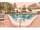 Community pool with lounge chairs and palm trees, ideal for relaxation at 1136 Thayer St, Safety Harbor, FL 34695