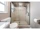 Bathroom with a glass shower door, toilet, and tile surround at 1403 Tallahassee Dr, Tarpon Springs, FL 34689