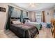Bright bedroom with light-colored flooring, two beds, large windows and modern ceiling fan at 1403 Tallahassee Dr, Tarpon Springs, FL 34689