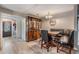 Dining area with a built-in bench, display cabinet, and wood-look tile flooring at 1403 Tallahassee Dr, Tarpon Springs, FL 34689