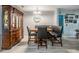Dining area with a built-in bench, display cabinet, and wood-look tile flooring at 1403 Tallahassee Dr, Tarpon Springs, FL 34689