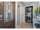 Hallway with decorative door, stacked washer and dryer, and wood-look tile flooring at 1403 Tallahassee Dr, Tarpon Springs, FL 34689