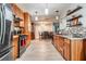 Well-appointed kitchen with wooden cabinets, stainless steel appliances, and an adjacent dining area at 1403 Tallahassee Dr, Tarpon Springs, FL 34689