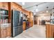 Stylish kitchen with black appliances, wood cabinets, and a view to the dining room at 1403 Tallahassee Dr, Tarpon Springs, FL 34689