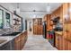 Well-lit kitchen showcasing wood cabinets, tile backsplash, and stainless steel appliances at 1403 Tallahassee Dr, Tarpon Springs, FL 34689