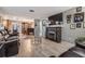 Comfortable living room with a fireplace, mounted TV, and wood-look flooring at 1403 Tallahassee Dr, Tarpon Springs, FL 34689