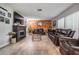 Spacious living room with a fireplace, brick accent wall, and wood-look flooring at 1403 Tallahassee Dr, Tarpon Springs, FL 34689