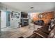 Cozy living room features a brick accent wall, a fireplace, and ample seating at 1403 Tallahassee Dr, Tarpon Springs, FL 34689
