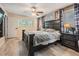 Inviting bedroom with dark furnishings, ceiling fan, and windows providing natural light at 1403 Tallahassee Dr, Tarpon Springs, FL 34689