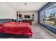 Relaxing main bedroom featuring a large window view, dresser with TV and simple decor at 1403 Tallahassee Dr, Tarpon Springs, FL 34689