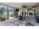 Inviting covered patio with brick floors, ceiling fan, and outdoor entertainment setup for relaxation at 1403 Tallahassee Dr, Tarpon Springs, FL 34689