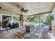 Enclosed patio with brick flooring, a ceiling fan, and a view of the private pool at 1403 Tallahassee Dr, Tarpon Springs, FL 34689