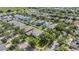 Aerial view of a residential neighborhood with mature trees and well-maintained homes at 15420 Quail Woods Pl, Ruskin, FL 33573