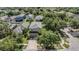 Aerial view of a two-story home featuring mature landscaping and a driveway leading to a two-car garage at 15420 Quail Woods Pl, Ruskin, FL 33573